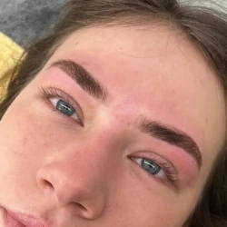 a closeup of a woman's face showing her eyebrows done well as part of a beauty treatment by waxination.nl in Amsterdam