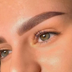 a closeup of a woman's face showing her eyebrows done well as part of a beauty treatment by waxination.nl in Amsterdam
