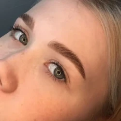 a closeup of a young woman's face showing her eyebrows done well as part of a beauty treatment by waxination.nl in Amsterdam